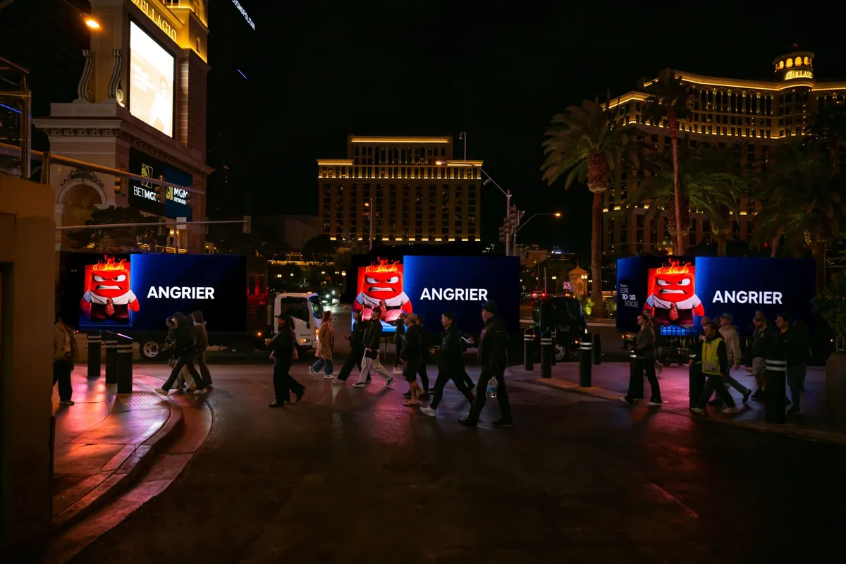 Las Vegas mobile billboard trucks displaying Disney campaign at night near the Bellagio